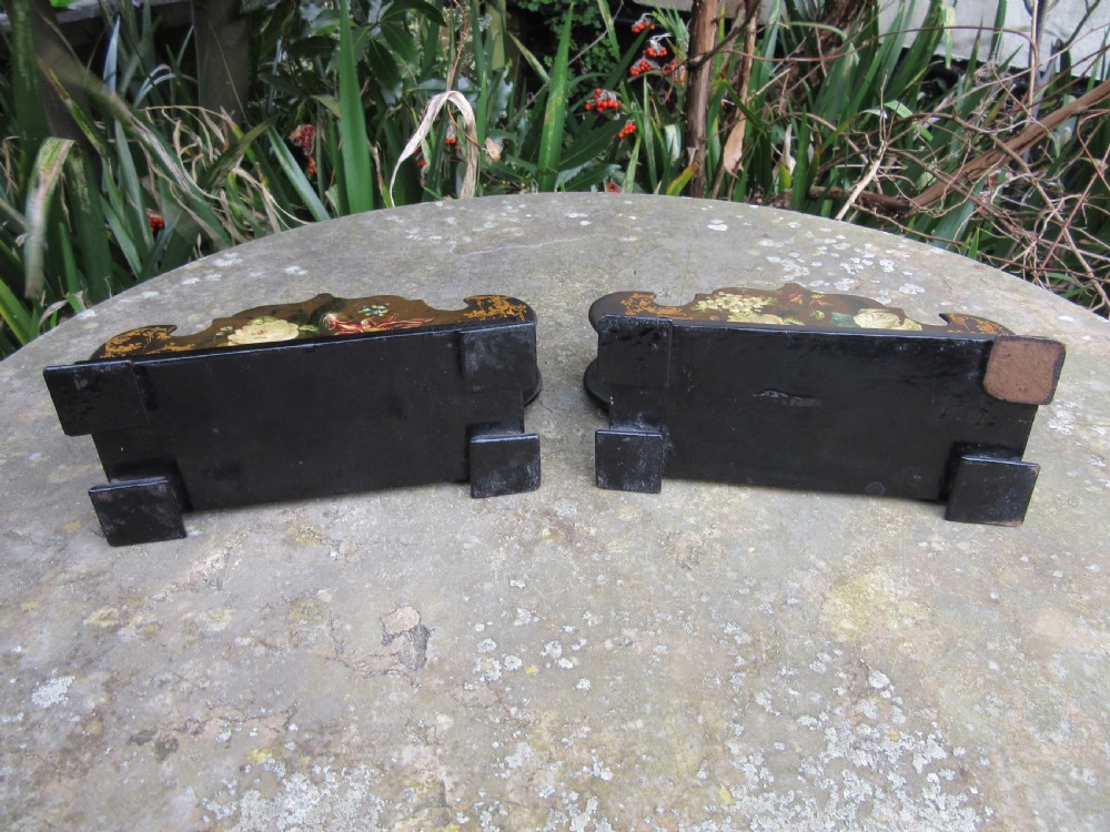 A pair of Regency black papier-mache letter stands decorated with hand-painted floral motifs and gilded foliage on stepped rectangular bases. View III
