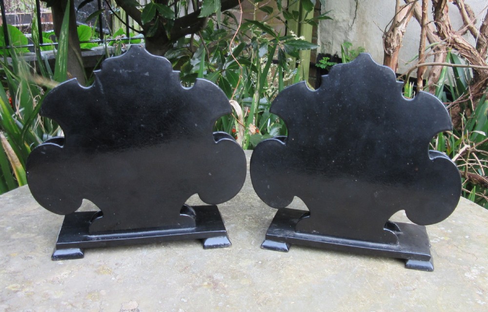 A pair of Regency black papier-mache letter stands decorated with hand-painted floral motifs and gilded foliage on stepped rectangular bases. View IV