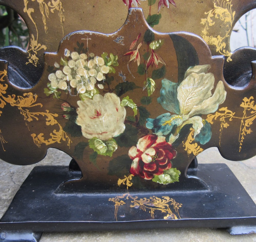 A pair of Regency black papier-mache letter stands decorated with hand-painted floral motifs and gilded foliage on stepped rectangular bases. View VII