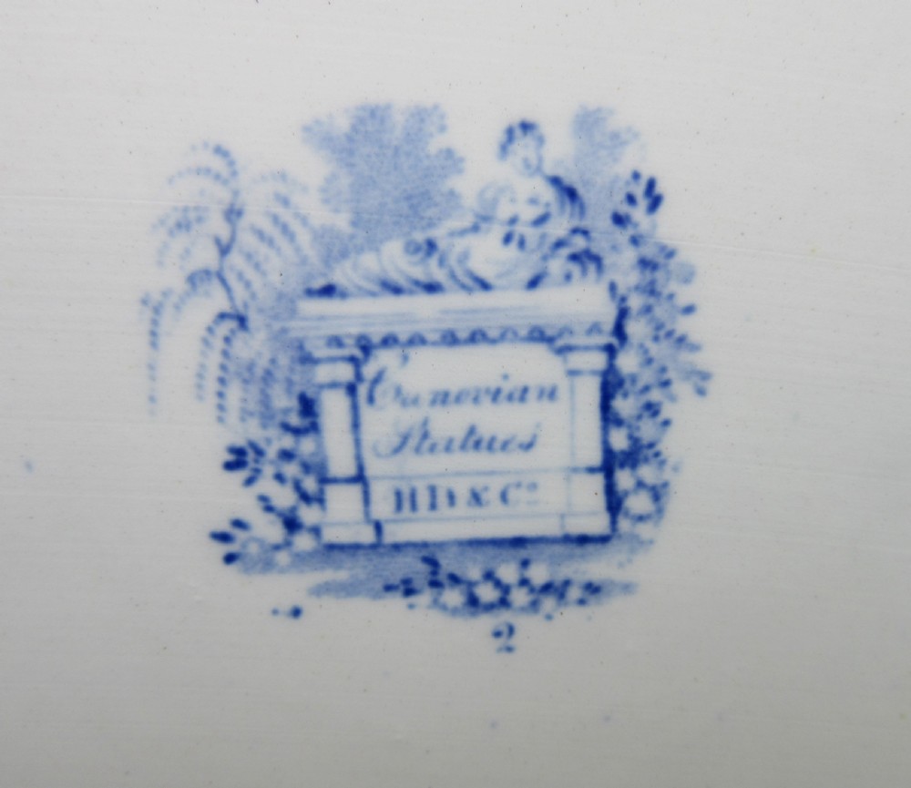 A rectangular blue and white transferware platter decorated with classical statues, buildings, and a sailboat scene with molded side handles. View III