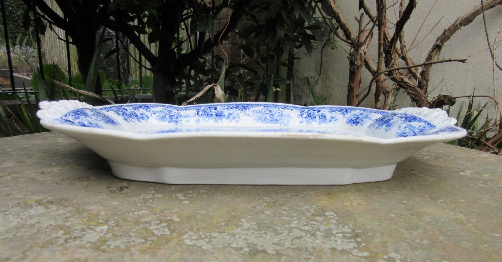 A rectangular blue and white transferware platter decorated with classical statues, buildings, and a sailboat scene with molded side handles. View IV