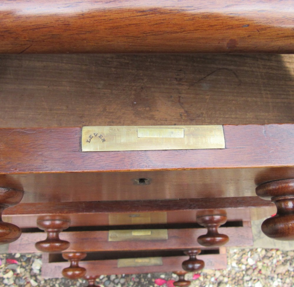 A nineteenth-century Victorian mahogany pedestal desk featuring a blue leather writing surface, multiple drawers with wooden turned handles, and twin pedestal supports. View VII