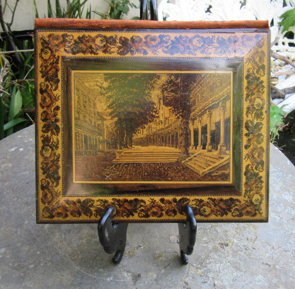 A Victorian Tunbridge ware writing folder featuring a micro-mosaic wood inlay depicting The Pantiles surrounded by a floral mosaic border.