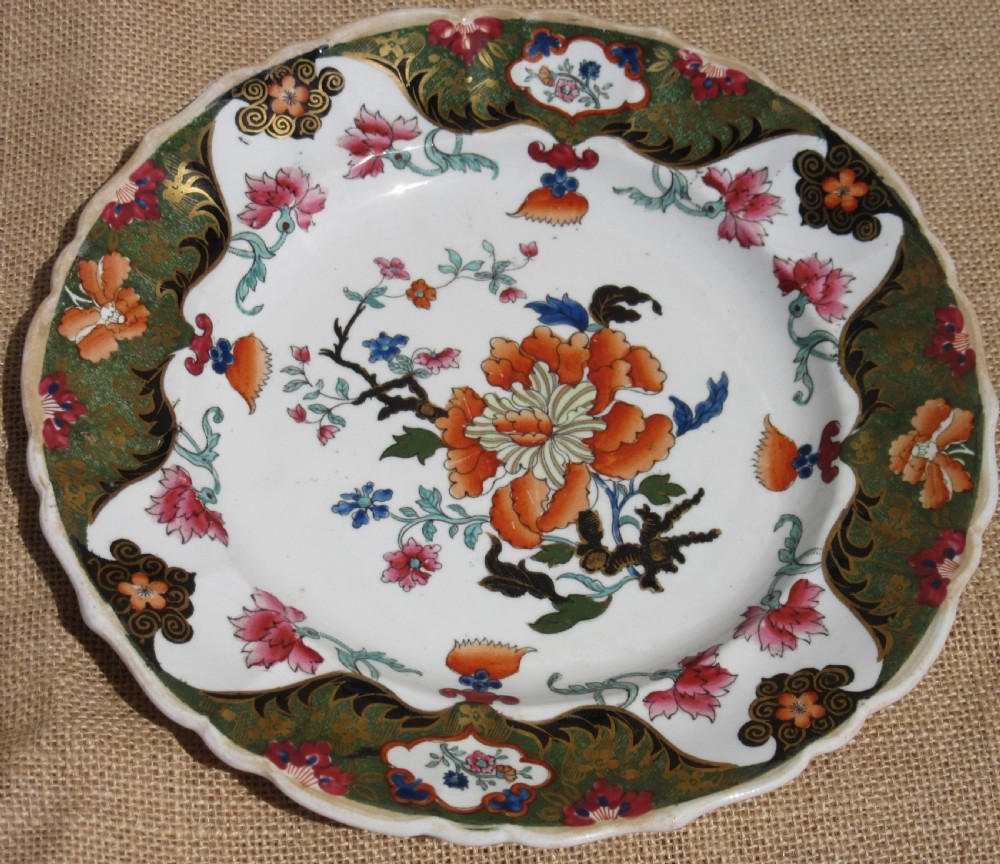 A Regency period Masons Patent Ironstone dessert service featuring hand-painted orange floral patterns and dark green gilded scalloped borders. View VI