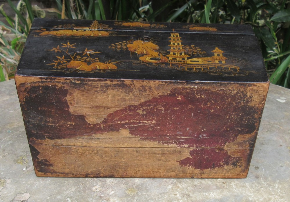 A black lacquered sarcophagus-shaped Regency tea caddy decorated with gilded Chinoiserie landscapes, pagodas, and foliage. View III
