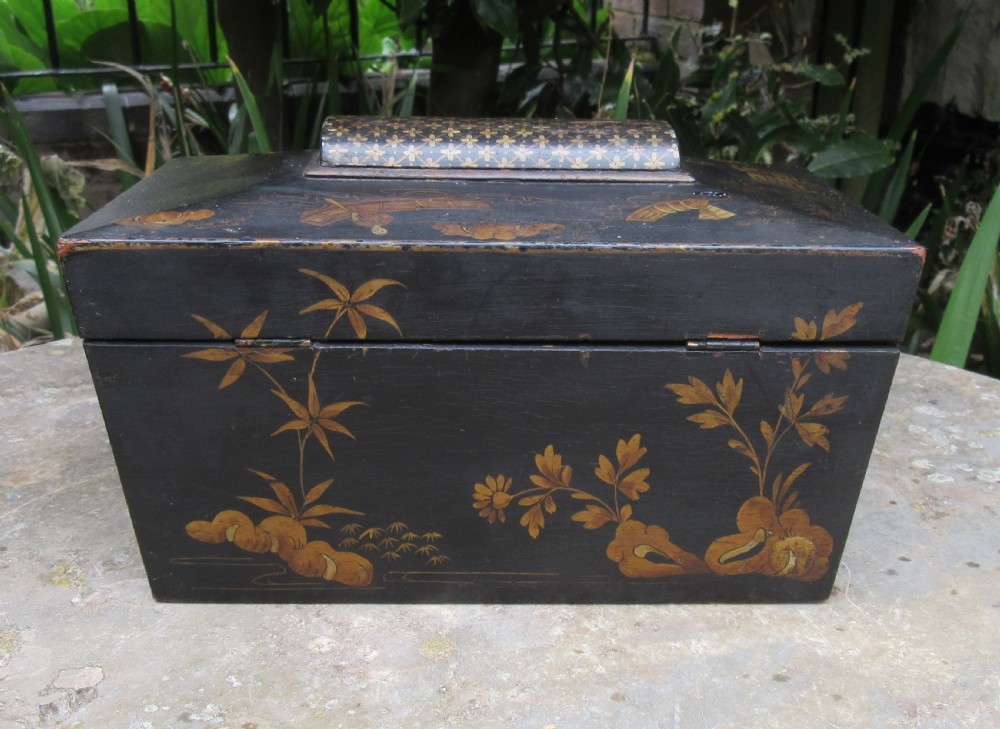 A black lacquered sarcophagus-shaped Regency tea caddy decorated with gilded Chinoiserie landscapes, pagodas, and foliage. View VII