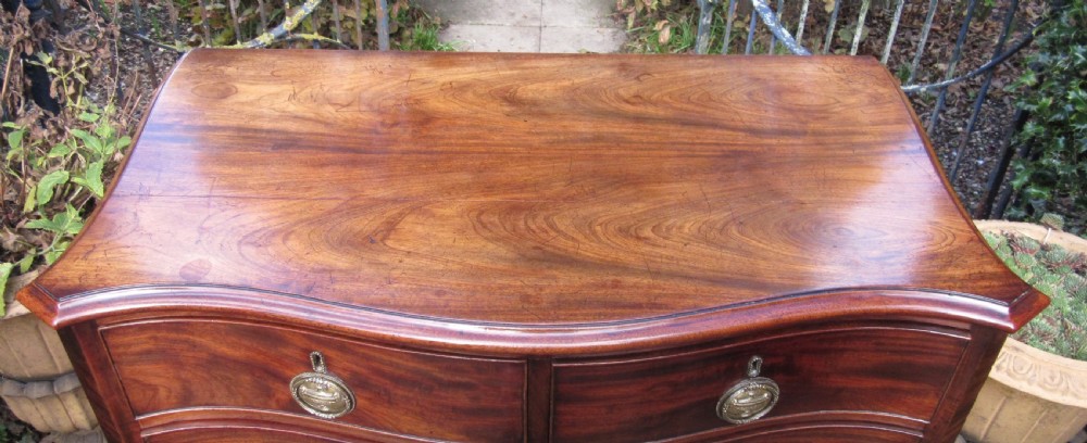 SMALL GEORGE III MAHOGANY SERPENTINE CHEST OF DRAWERS View III