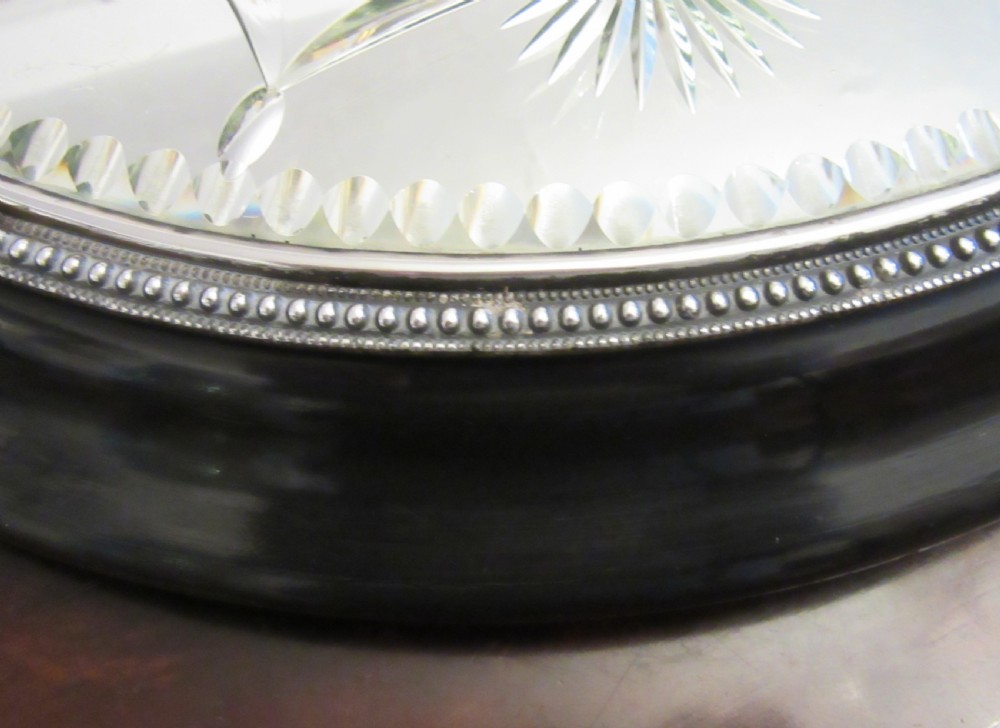 A circular Victorian mirrored table plateau featuring wheel-cut starburst patterns framed by a beaded metal rim on a turned ebonised wood base. View V