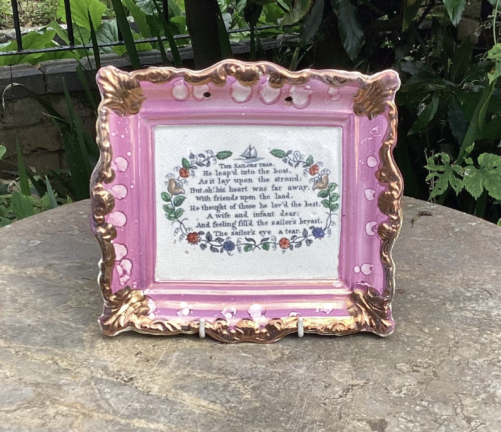 A square Victorian Sunderland pink splash lustreware pottery plaque printed with the poem The Sailors Tear within an ornate moulded frame.