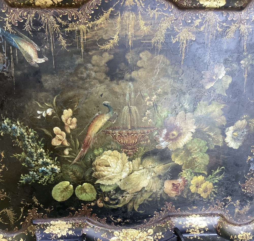 A dark shaped Regency toleware tray featuring hand-painted botanical flowers, a bird, and elaborate gilded border embellishments. View IV