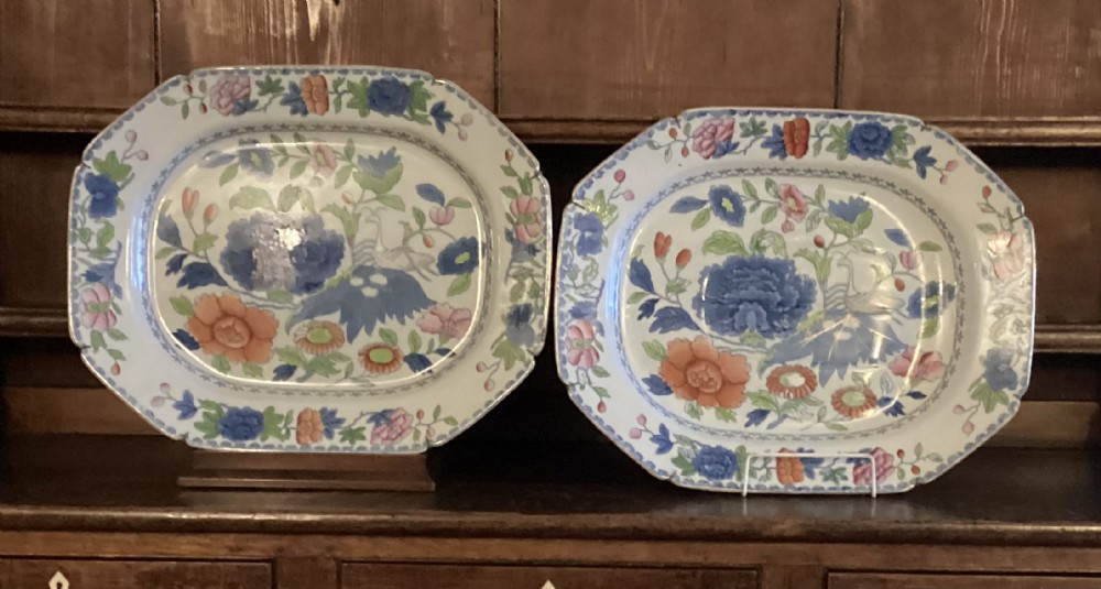 A pair of octagonal Regency period Masons ironstone serving platters decorated with polychrome chinoiserie floral patterns.