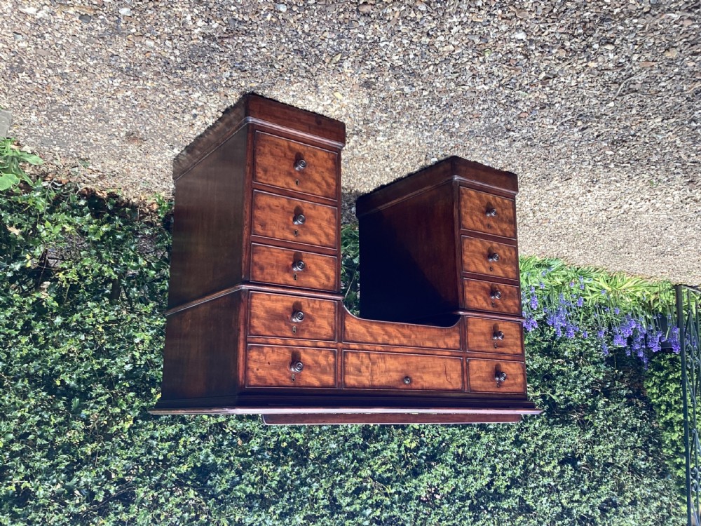 A mahogany pedestal desk featuring an adjustable drafting slope top, multiple small drawers with turned knobs, and a central kneehole. View III