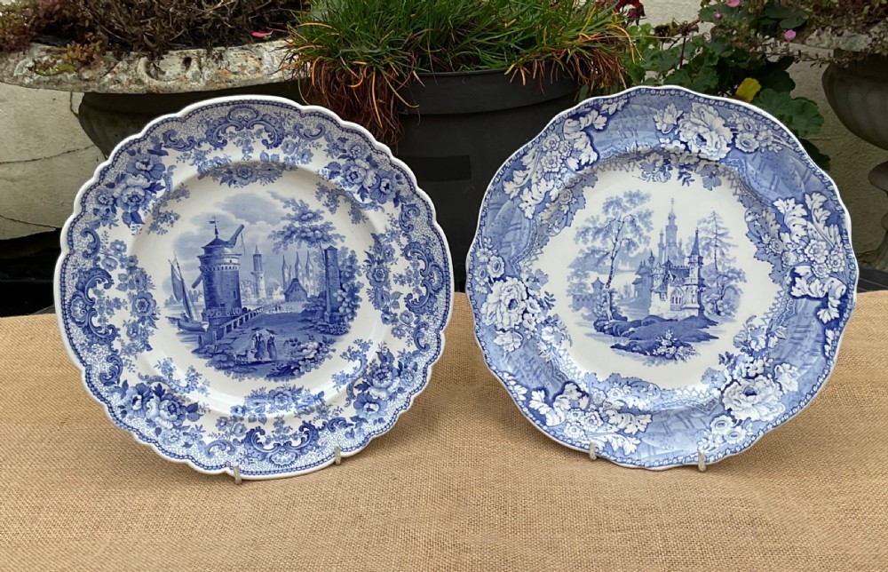 A group of six early 19th-century Staffordshire blue and white transferware ceramic plates displaying pastoral, coastal, and floral patterns with scalloped borders. View II