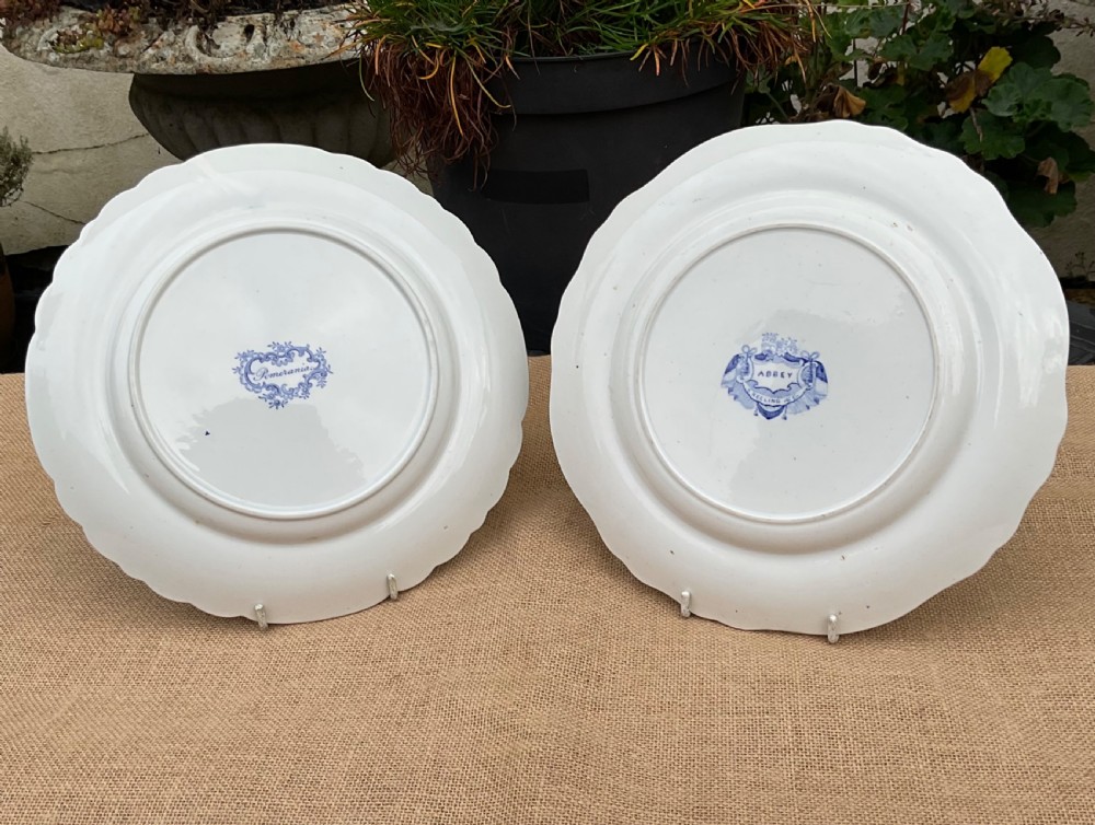 A group of six early 19th-century Staffordshire blue and white transferware ceramic plates displaying pastoral, coastal, and floral patterns with scalloped borders. View III