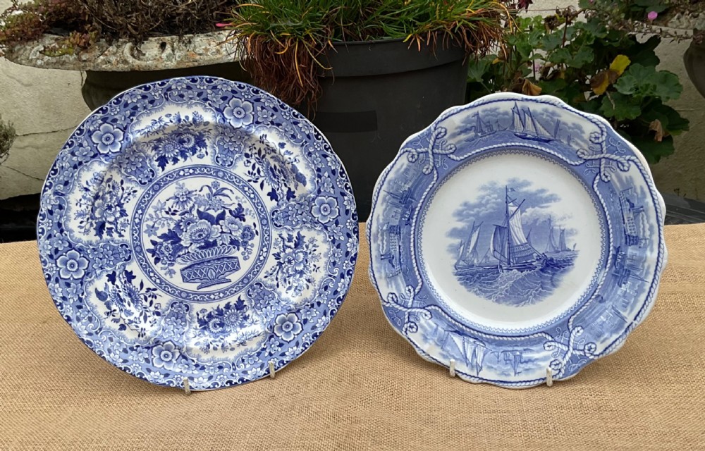 A group of six early 19th-century Staffordshire blue and white transferware ceramic plates displaying pastoral, coastal, and floral patterns with scalloped borders. View IV