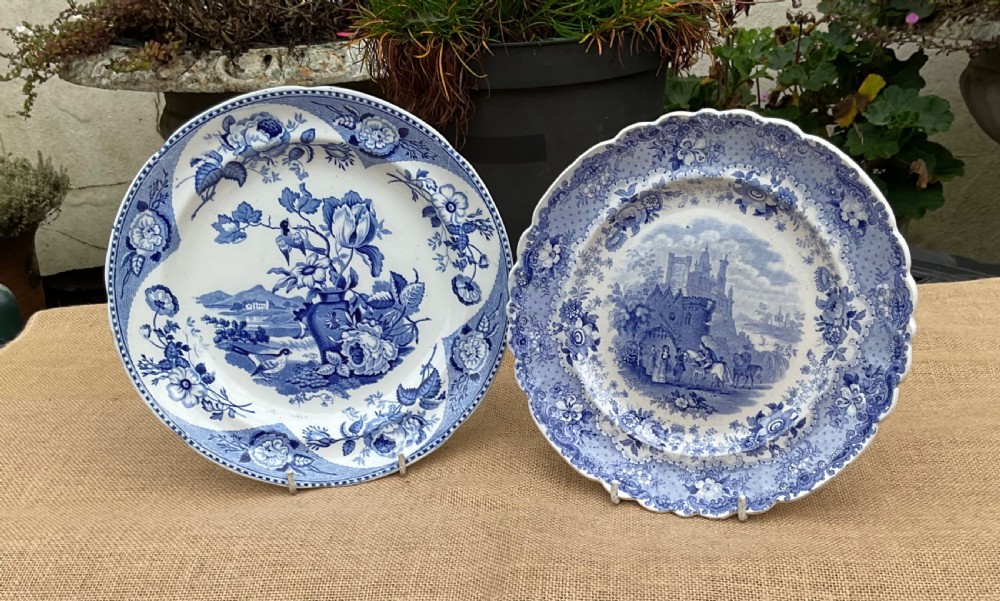 A group of six early 19th-century Staffordshire blue and white transferware ceramic plates displaying pastoral, coastal, and floral patterns with scalloped borders. View VI