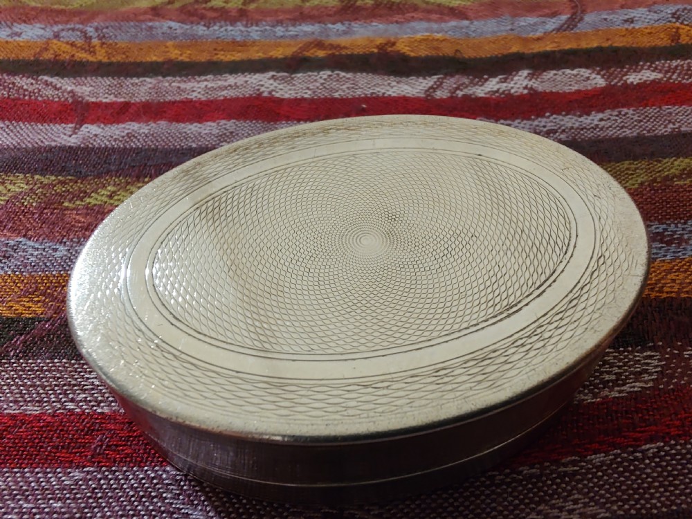 An oval Edwardian silver snuff box with an engraved dot pattern along the edge of the lid. View VII