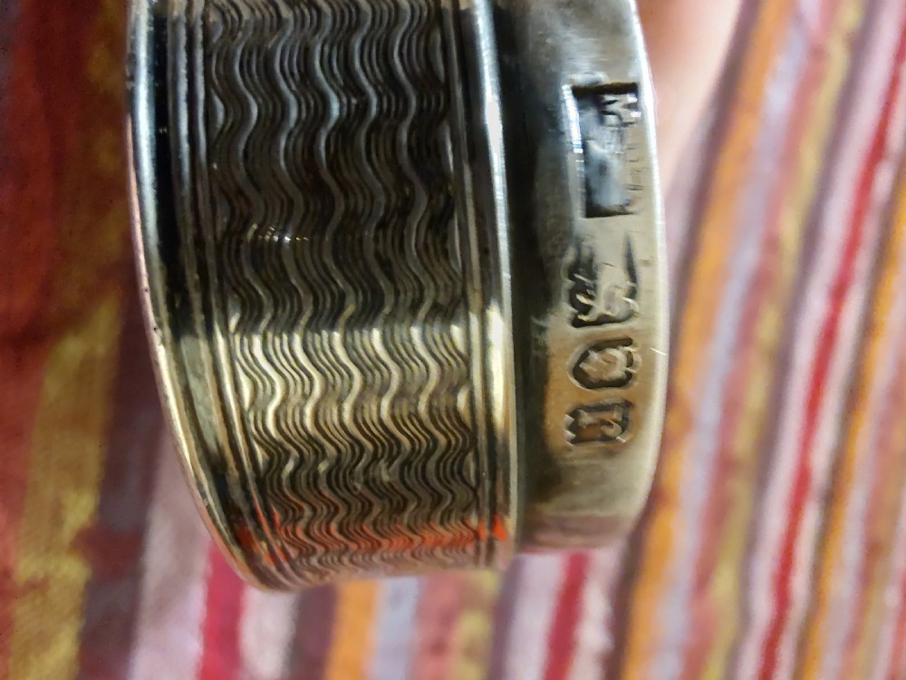 An oval Edwardian silver snuff box with an engraved dot pattern along the edge of the lid. View XII