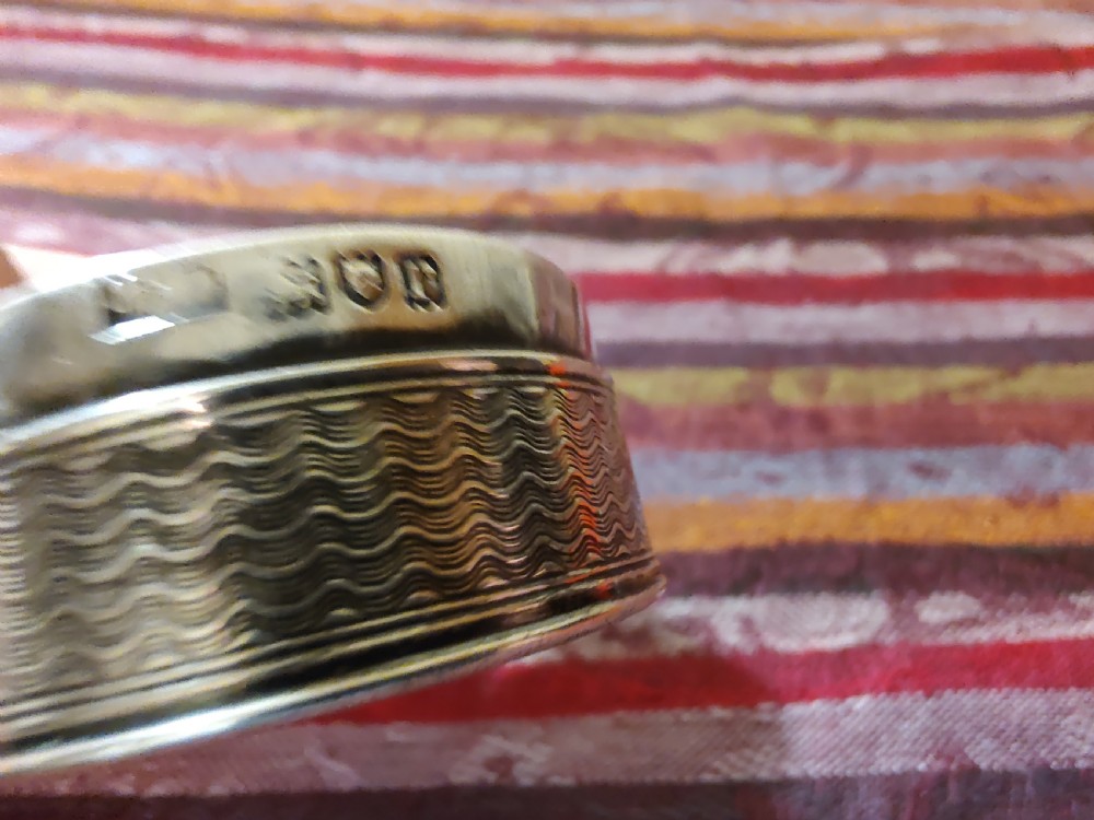 An oval Edwardian silver snuff box with an engraved dot pattern along the edge of the lid. View XIII
