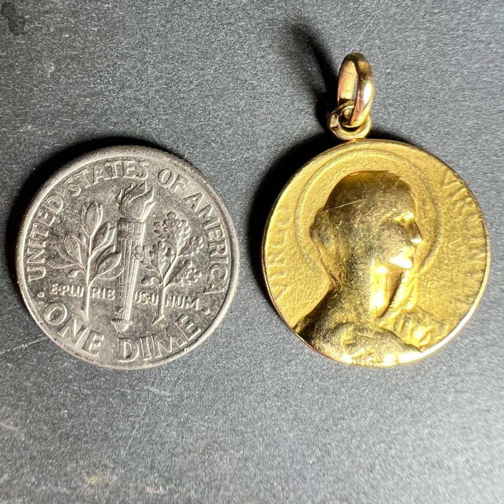 A circular 18K yellow gold medal pendant featuring an embossed profile of the Virgin Mary encircled by a halo and Latin text. View XI