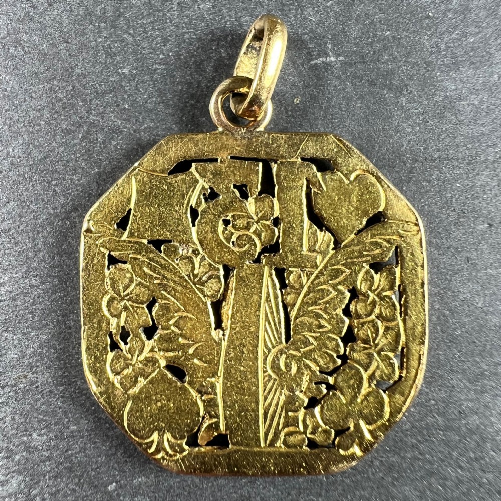 An octagonal 18ct yellow gold openwork charm pendant featuring the number 13, playing card suits, a wheel, and four-leaf clovers. View III