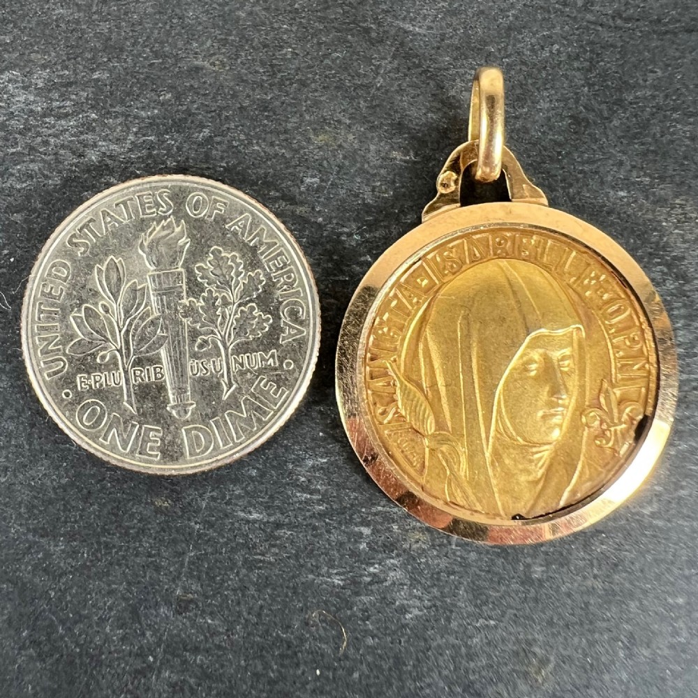 A circular 18ct yellow gold medal featuring a raised relief carving of Saint Isabelle of France with surrounding Latin text and top suspension loop. View XI