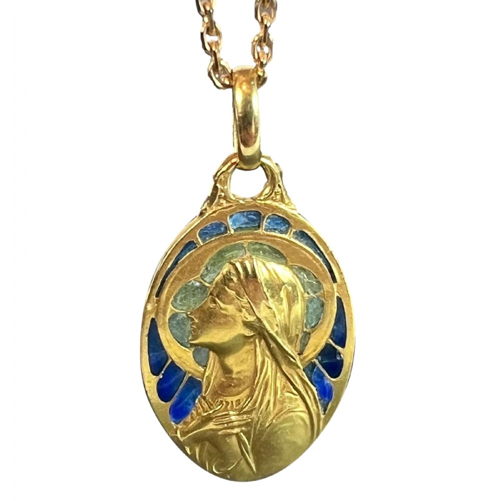 An oval 18ct yellow gold pendant featuring a relief profile of the Virgin Mary surrounded by blue and green plique-a-jour enamel.