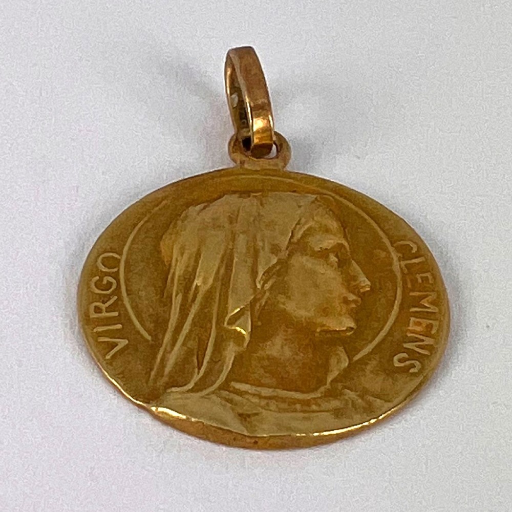 A circular 18K yellow gold medal featuring a relief profile of the veiled Virgin Mary surrounded by the Latin inscription Virgo Clemens. View XI