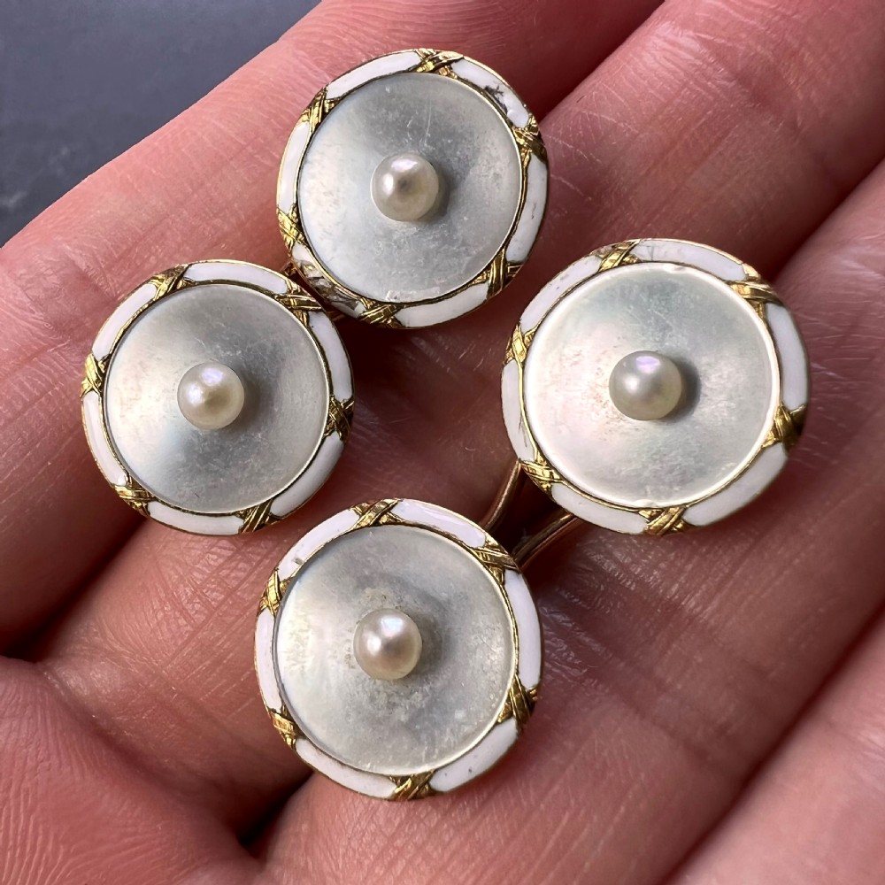 A set of double-sided French 18K yellow gold cufflinks with circular mother-of-pearl faces, central pearls, and white enamel borders. View XII