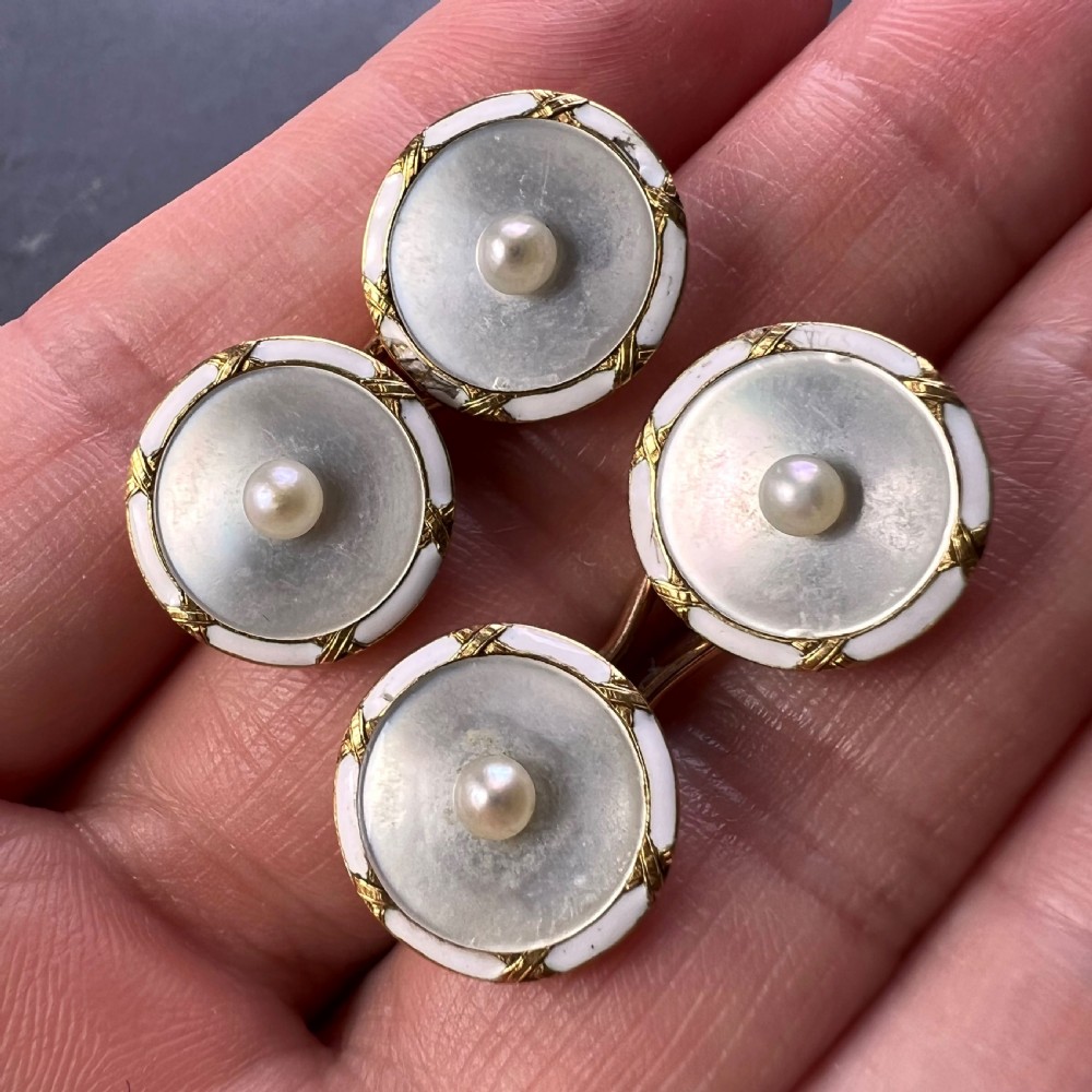 A set of double-sided French 18K yellow gold cufflinks with circular mother-of-pearl faces, central pearls, and white enamel borders. View XIII