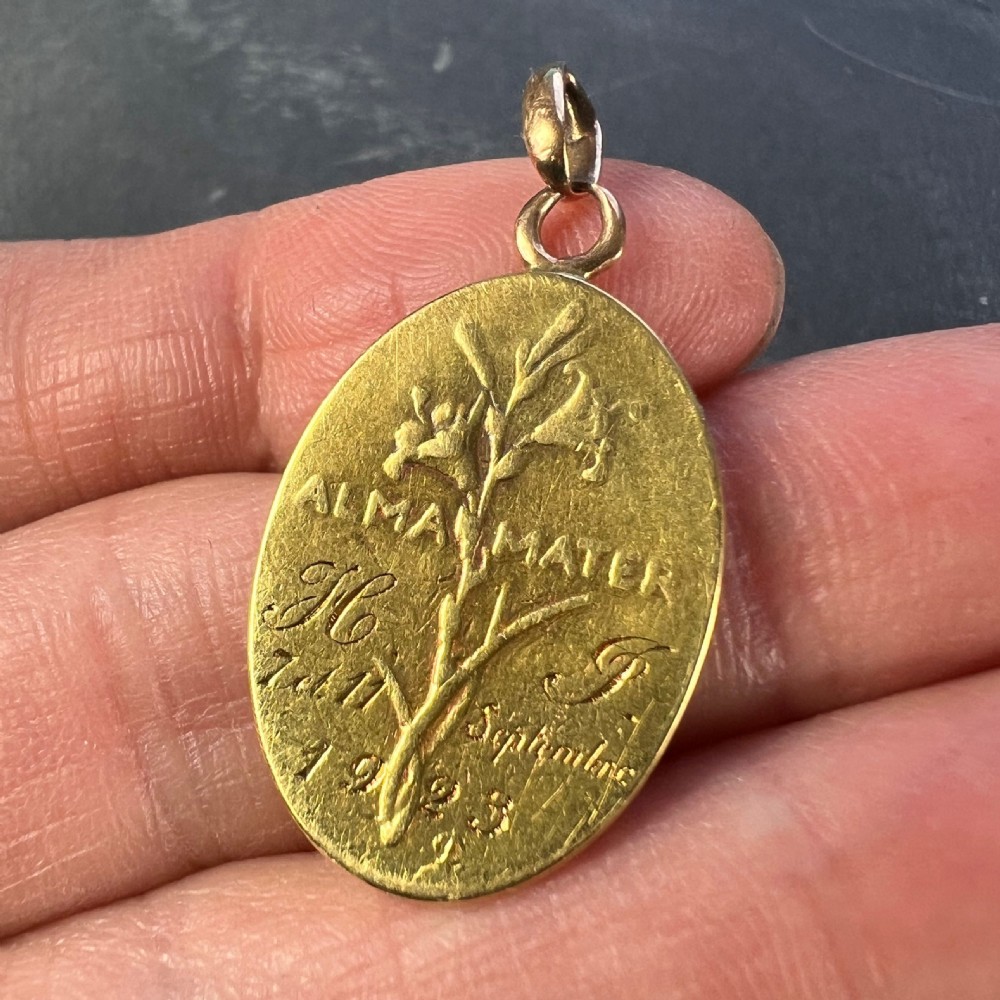 An oval 18ct yellow gold devotional pendant featuring a relief carving of the Madonna and Child. View VIII