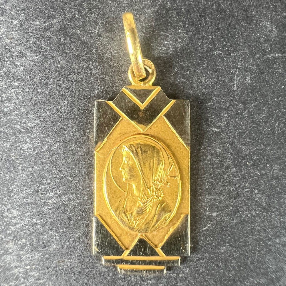 An Art Deco rectangular two-tone gold pendant featuring an oval central relief of the Virgin Mary surrounded by geometric white gold borders. View II