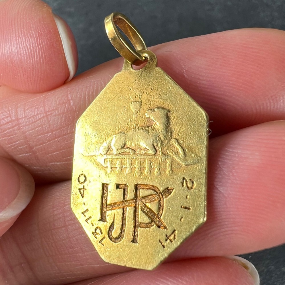 An octagonal 18k yellow gold Art Deco medal pendant featuring a bas-relief profile of Jesus Christ with a halo. View VIII