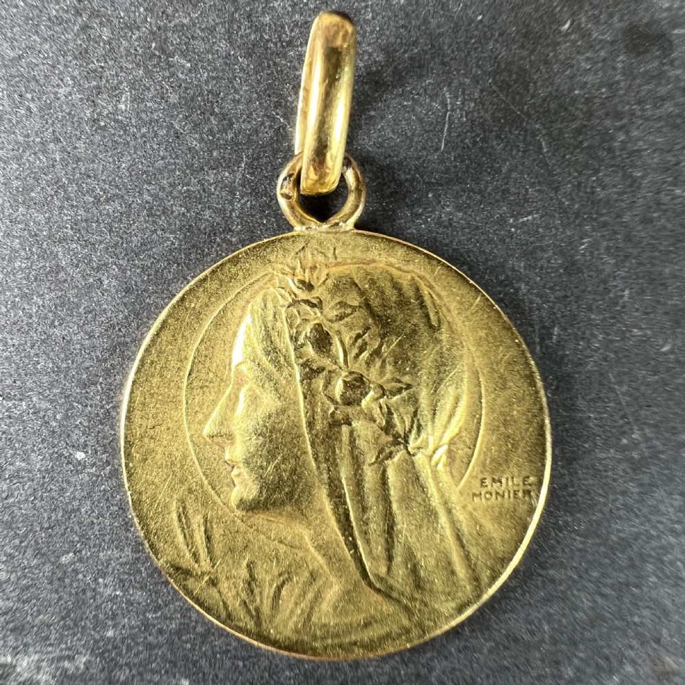 A circular 18k yellow gold pendant featuring a relief profile portrait of the Virgin Mary signed by Emile Monier. View II