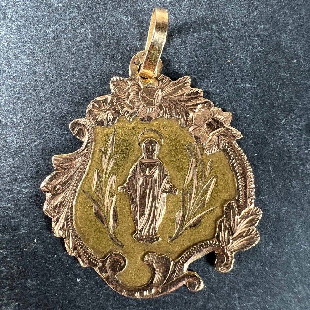 An antique French 18K yellow and rose gold religious pendant featuring an engraved Virgin Mary surrounded by a textured floral border. View II