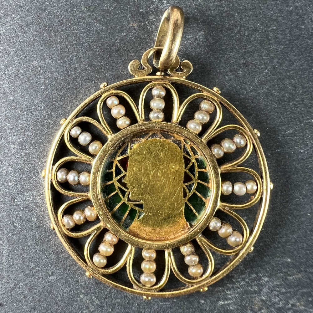 A circular 18K yellow gold pendant featuring a central profile bust of the Virgin Mary framed by green and red translucent plique-a-jour enamel and a outer ring of seed pearls set in wirework loops. View VIII
