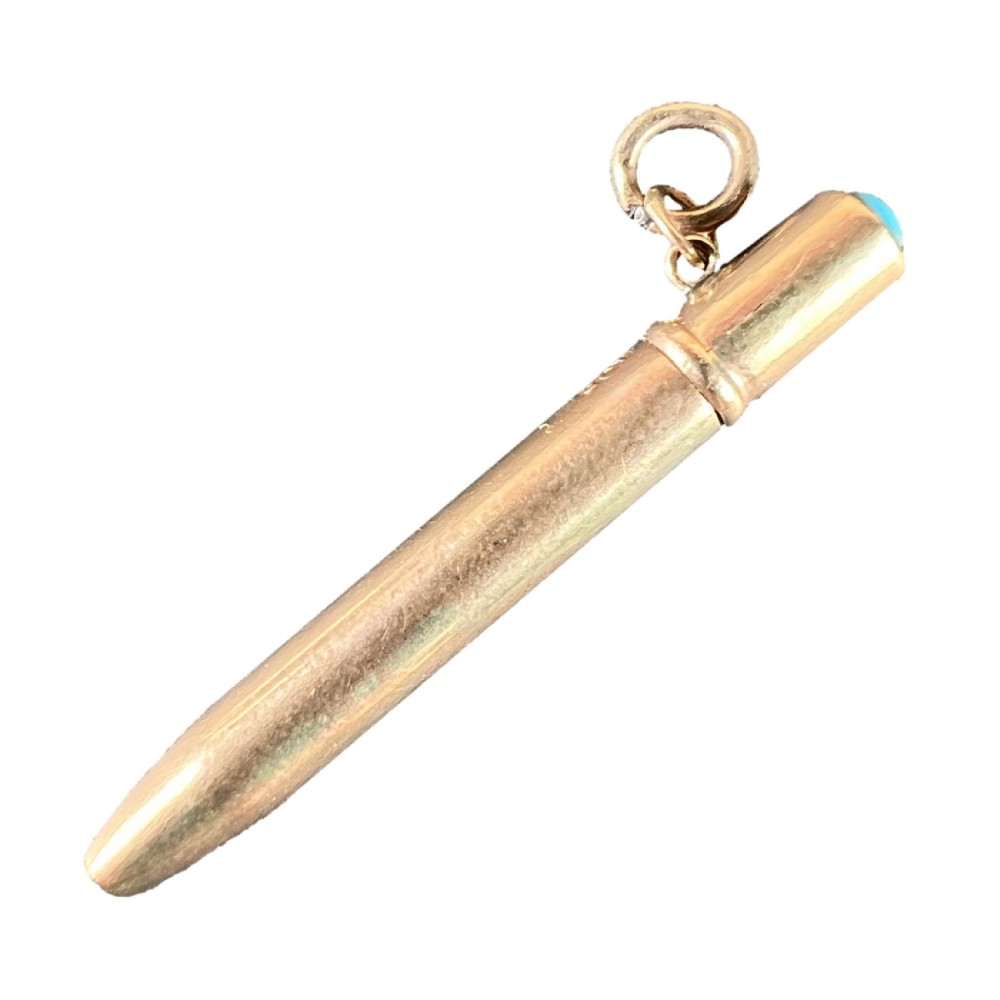 An antique Victorian 9ct rose gold propelling pencil charm featuring a smooth cylindrical barrel, suspension jump ring, and a turquoise cabochon set into the cap.