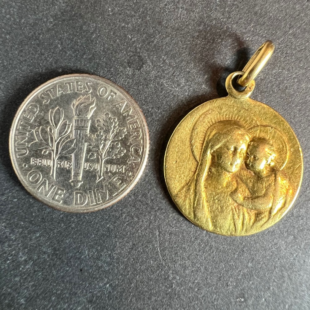 A circular 18-carat yellow gold religious medal pendant depicting the relief profile of the Madonna and Child. View XI