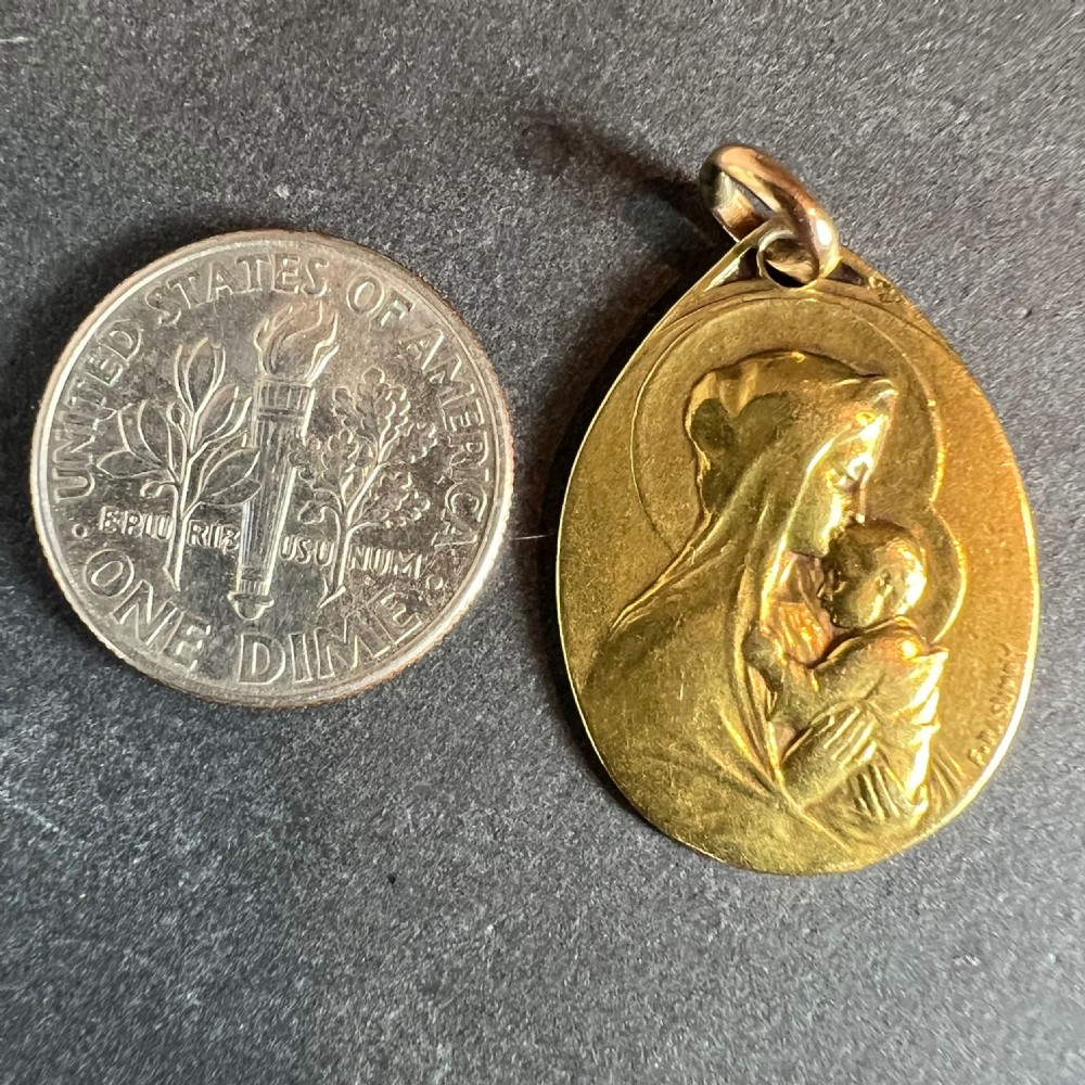 An oval 18-carat yellow gold antique religious medal featuring a bas-relief depiction of the Madonna and Child in profile, signed Rasumny. View XI