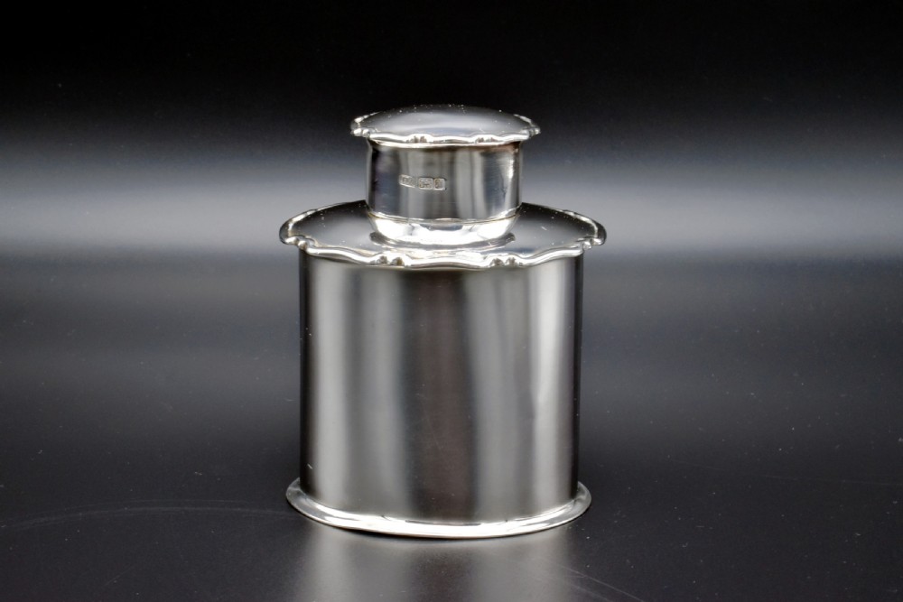 A cylindrical Edwardian sterling silver tea caddy with a scalloped edge lid and an engraved monogram on the front. View III