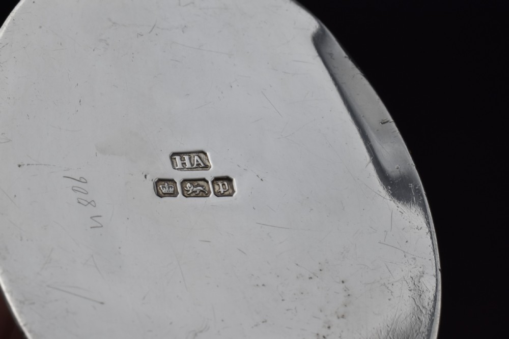 A cylindrical Edwardian sterling silver tea caddy with a scalloped edge lid and an engraved monogram on the front. View VII