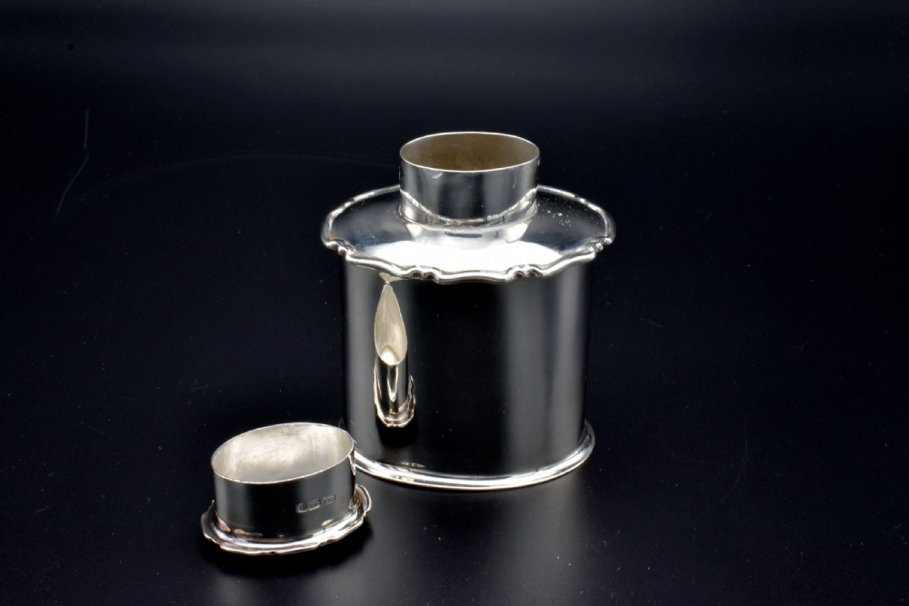 A cylindrical Edwardian sterling silver tea caddy with a scalloped edge lid and an engraved monogram on the front. View VIII