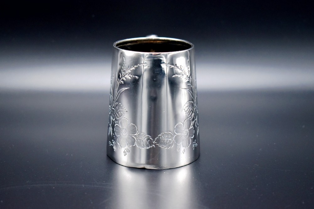 A late Victorian sterling silver tankard featuring etched floral motifs and British hallmarks near the top rim. View II