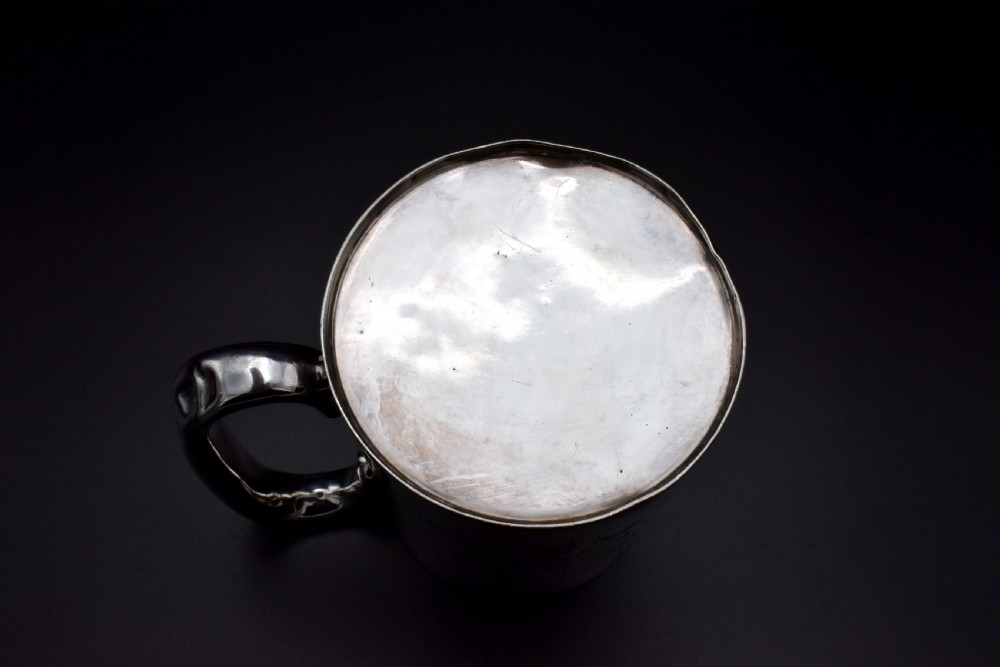 A late Victorian sterling silver tankard featuring etched floral motifs and British hallmarks near the top rim. View IV