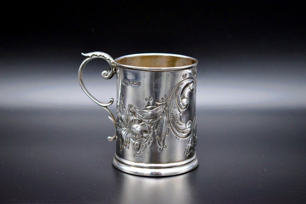 A late Victorian sterling silver tankard featuring etched floral motifs and British hallmarks near the top rim. View V