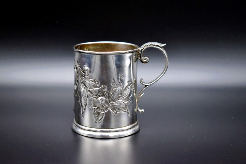 A late Victorian sterling silver tankard featuring etched floral motifs and British hallmarks near the top rim. View VII