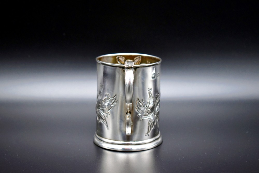 A late Victorian sterling silver tankard featuring etched floral motifs and British hallmarks near the top rim. View VIII