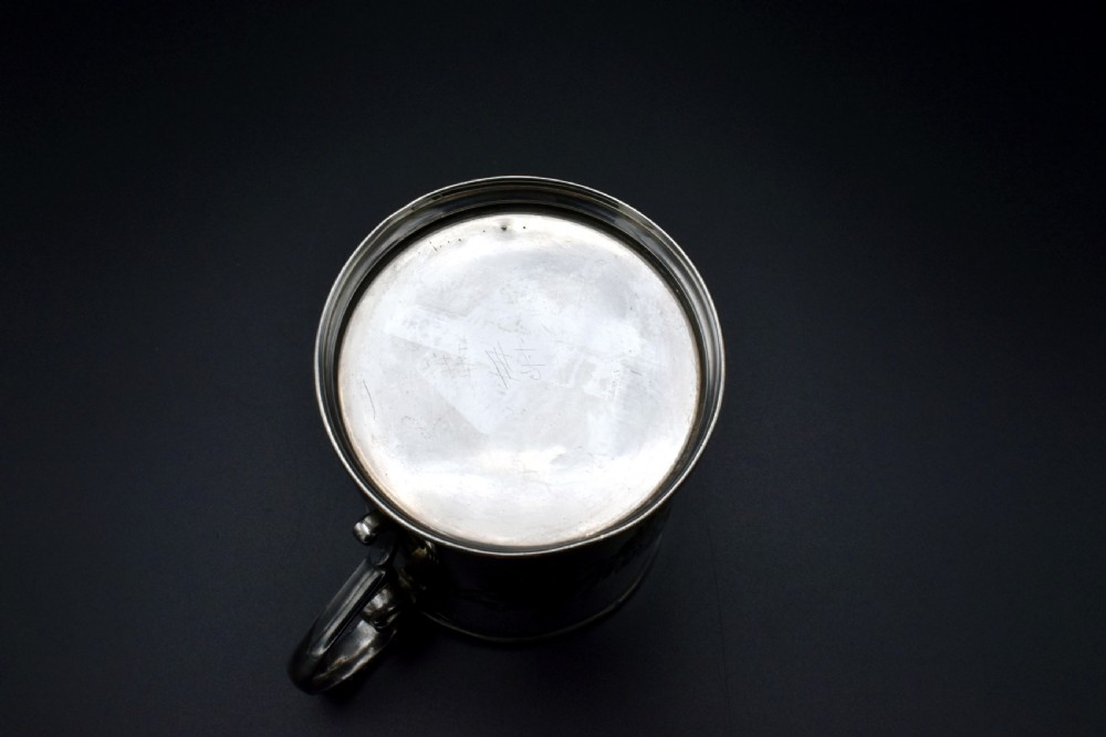 A late Victorian sterling silver tankard featuring etched floral motifs and British hallmarks near the top rim. View IX