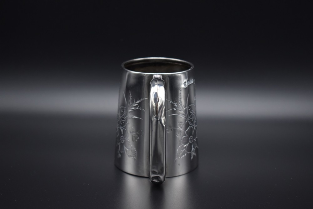 A late Victorian sterling silver tankard featuring etched floral motifs and British hallmarks near the top rim. View XI