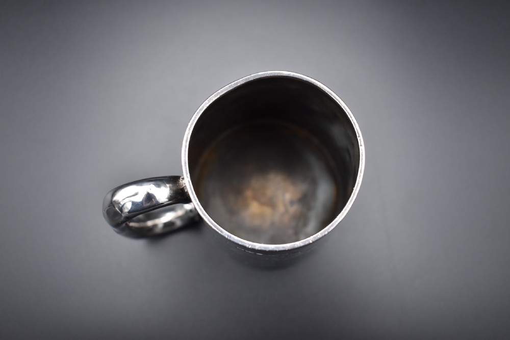 A late Victorian sterling silver tankard featuring etched floral motifs and British hallmarks near the top rim. View XII